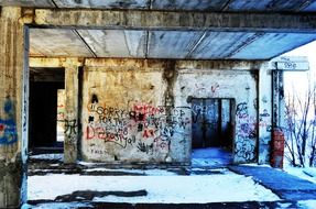 vandalism, grunge graffiti on walls of ruined abandoned building