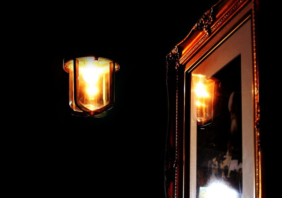 lantern at framed picture in darkness