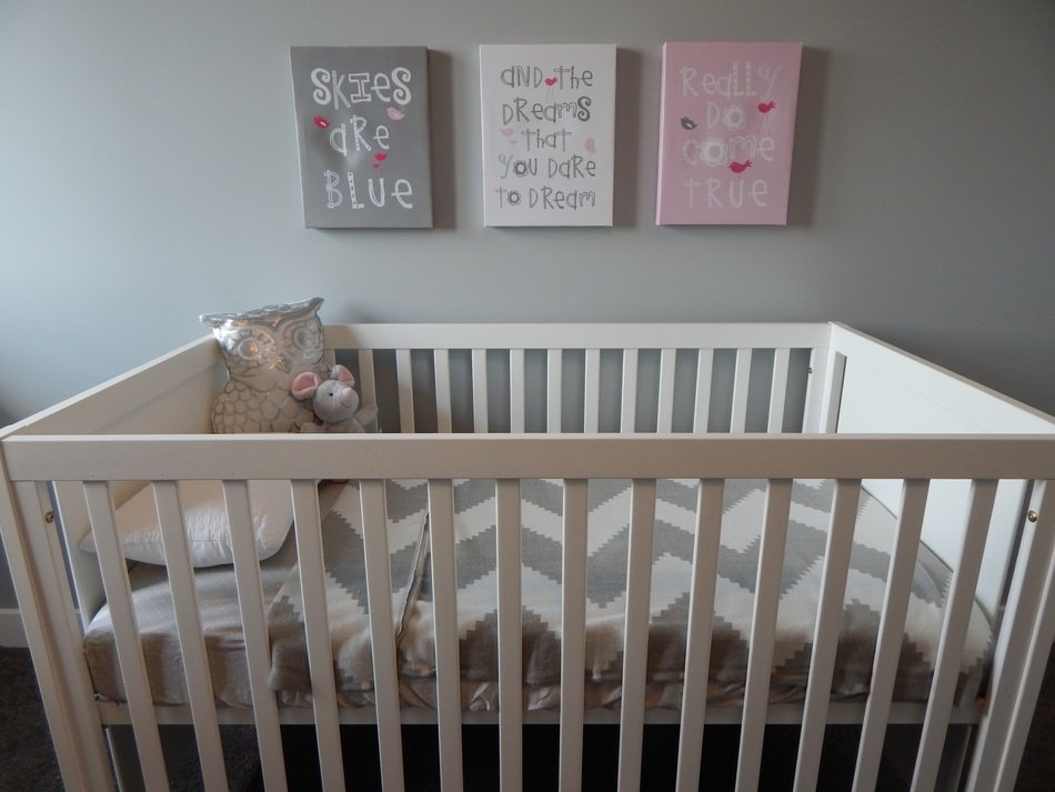 white crib with toys in bedroom
