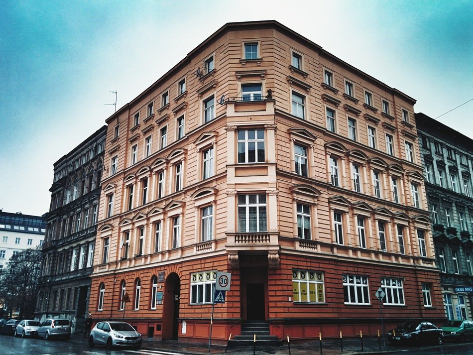 old red painted building on street corner