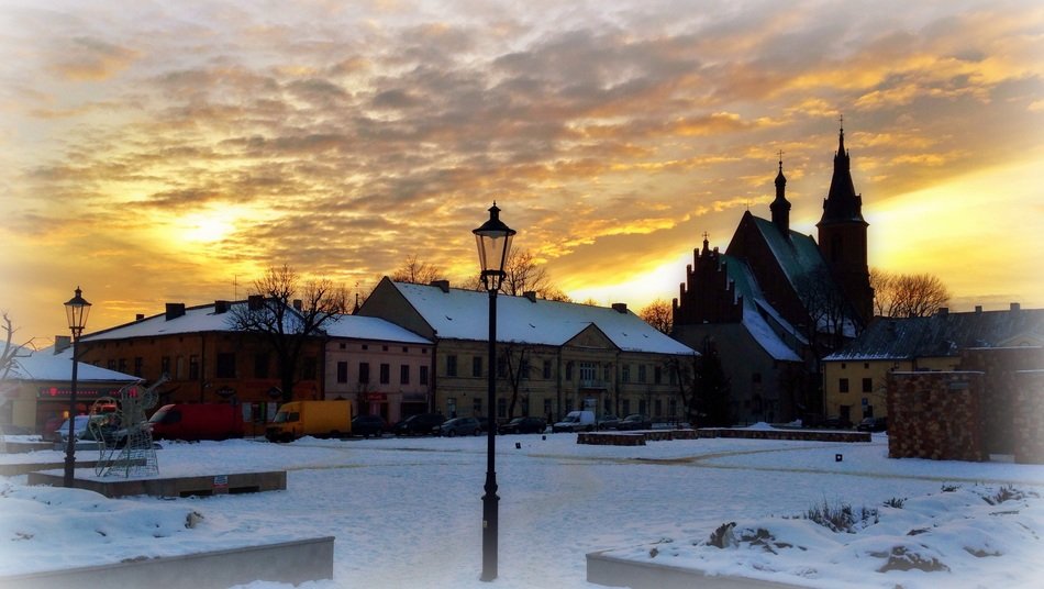 cloudy sky above old city at sunset, poland, olkusz