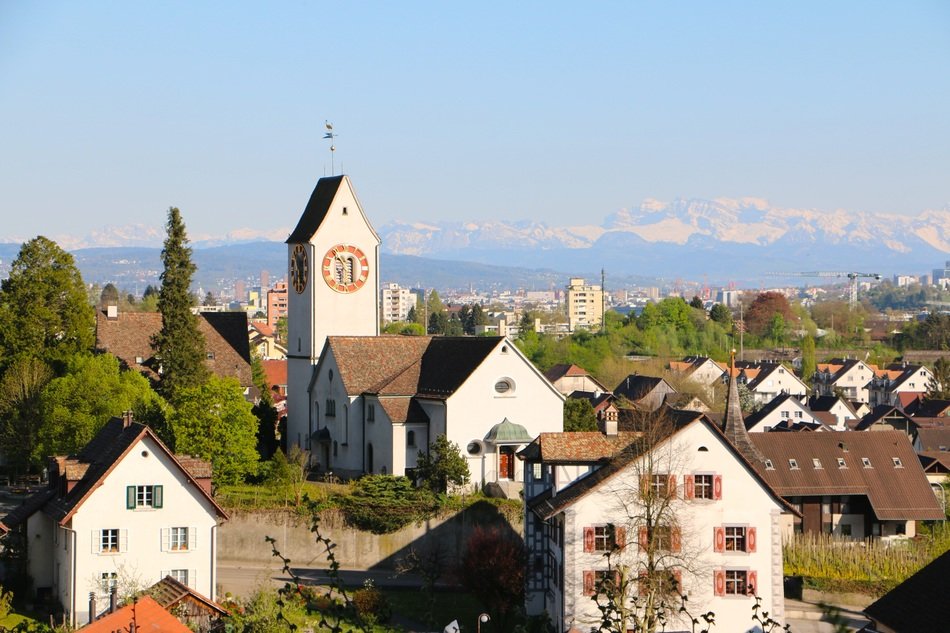 Church in town on the mountains background