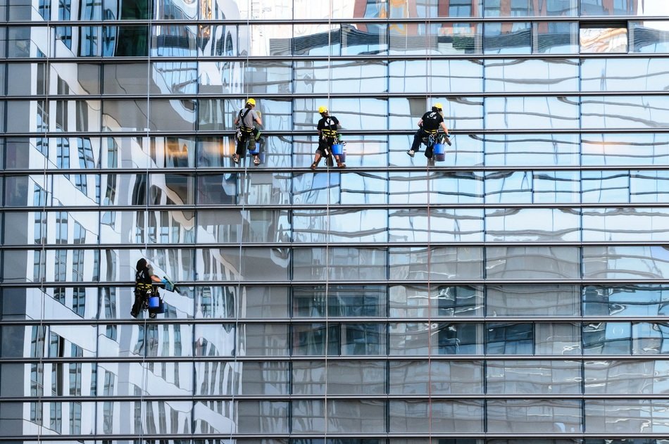 window cleaners at work on glass facade