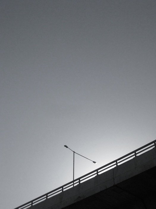 lamp post on overpass at sky, black and white