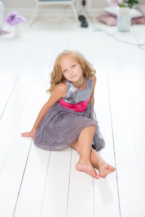 long haired child girl posing on floor