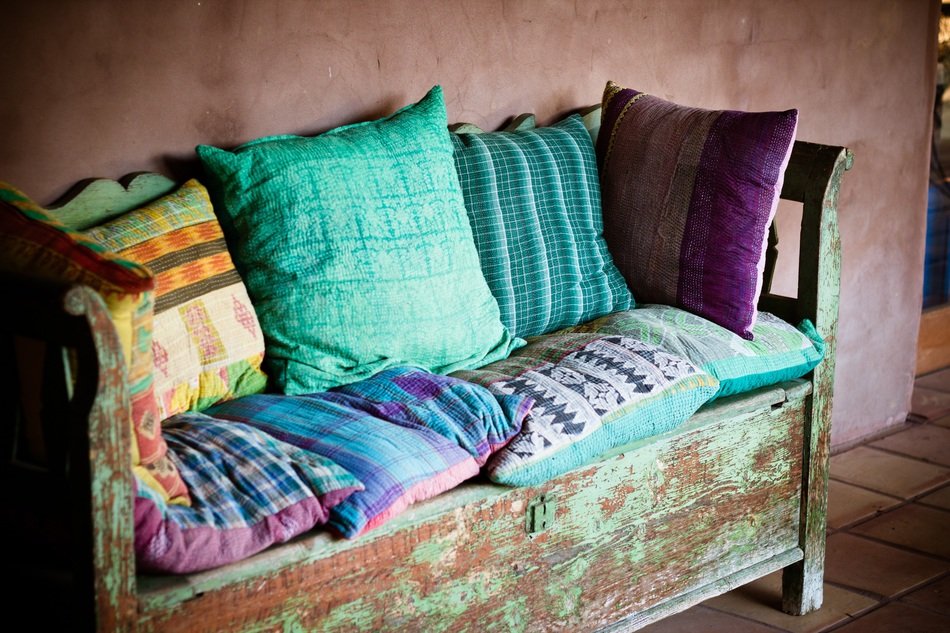 colorful pillows as decor on the old wood bench