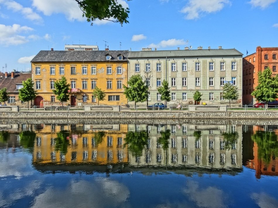 colorful houses with reflaction on calm water, poland, bydgoszcz