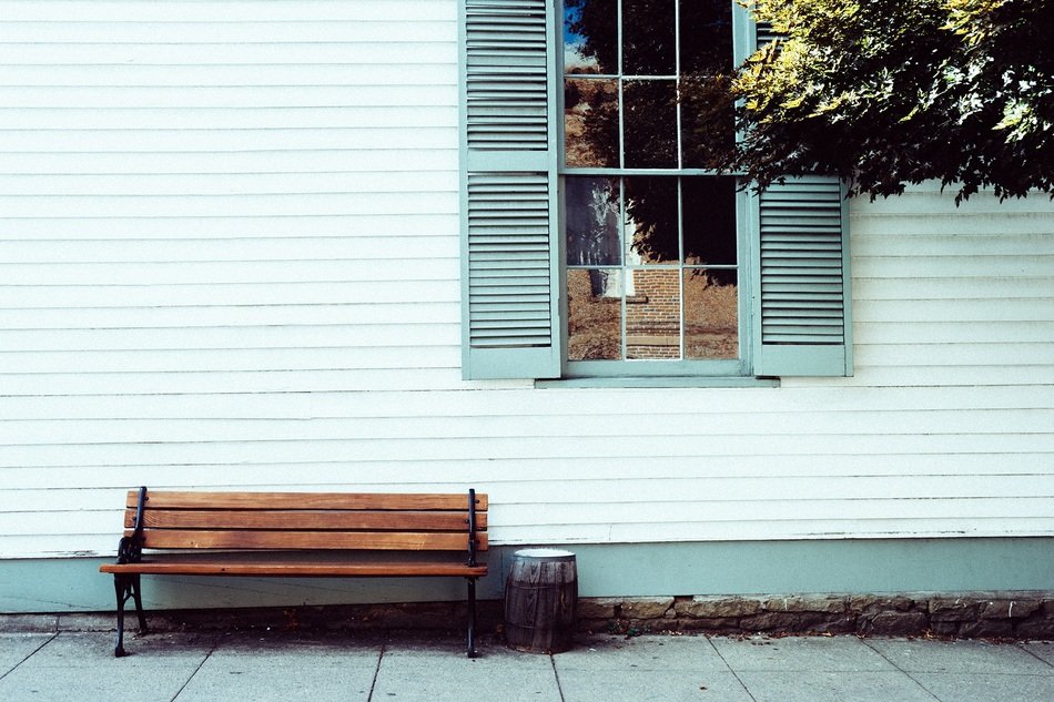 wooden bench in front of house