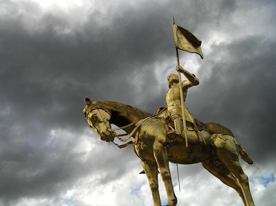 Jeanne d'Arc equestrian sculpture at cloudy sky, france, caens