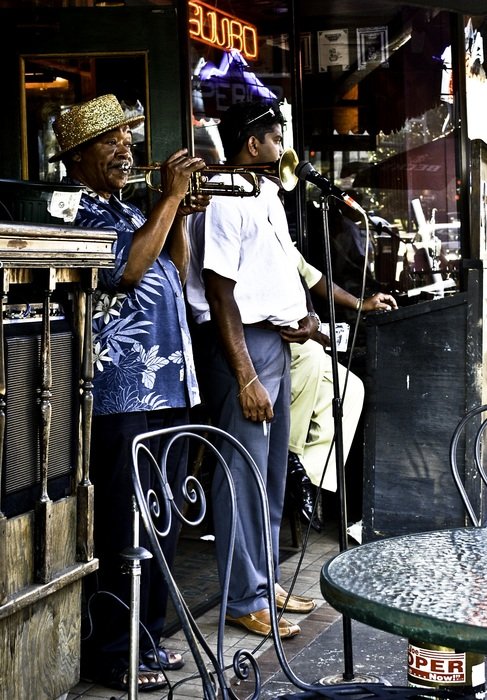 dark skin man paying trumpet, street performance