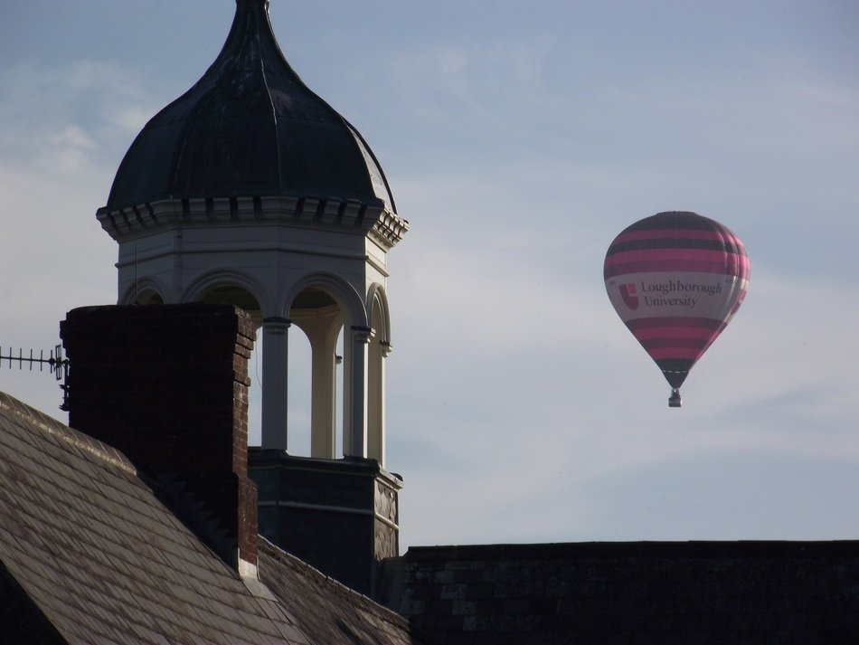 hot air balloon in sky at old tower