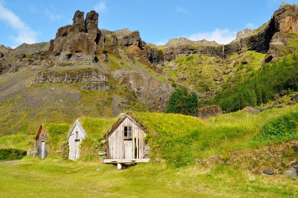 old wooden buildings at rocks, iceland