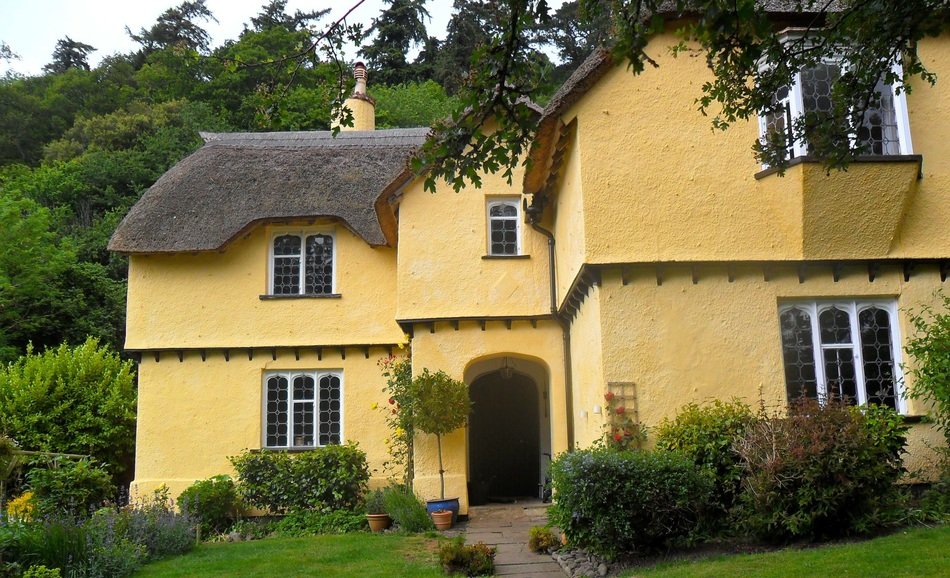 cottage with yellow walls in the countryside of england