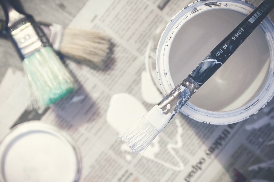 paint in can and brushes on paper
