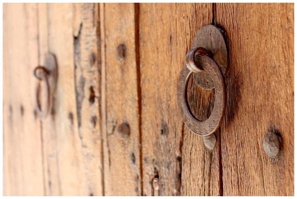 brass doorknocker on wooden door