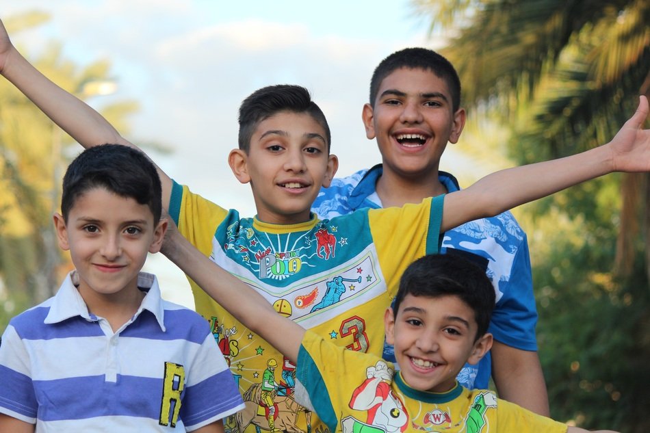 four iraq smiling bright summer clothes boys