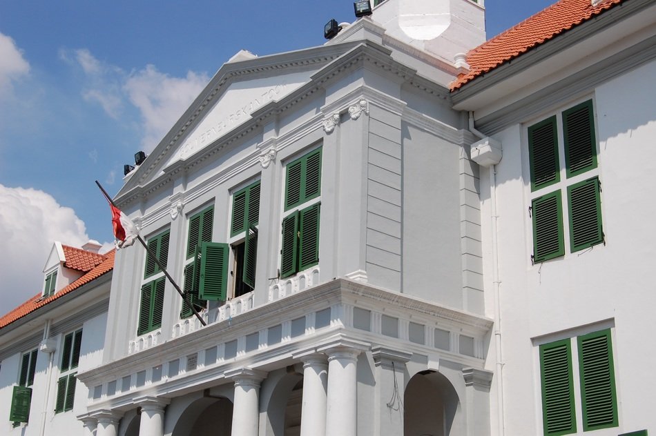 old building with flag on balcony, indonesia, jakarta