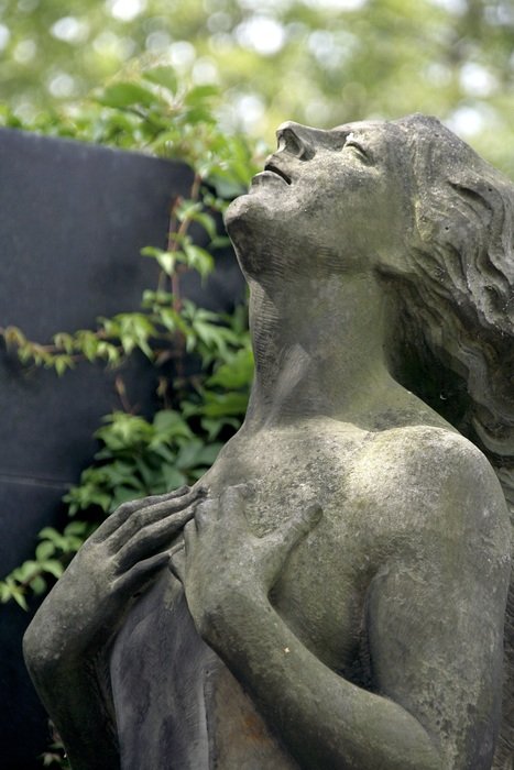 woman looking up, stone sculpture