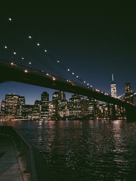 bridge at night skyline of new york city, usa