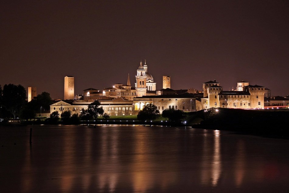 night skyline of old city at water, italy, mantova