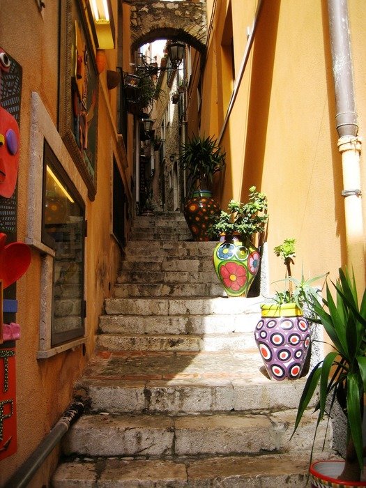 alley with potted plants on stone stairs in old town, spain, torremolinos