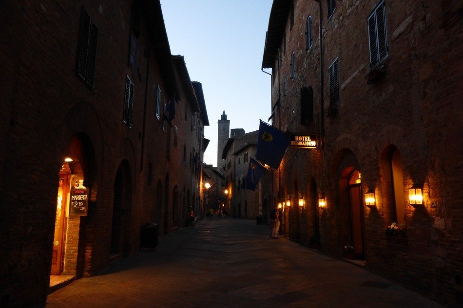 lanterns on facades in old town at dusk, italy