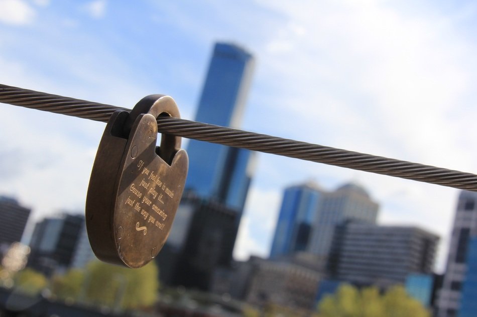 love lock on steel rope at cityscape