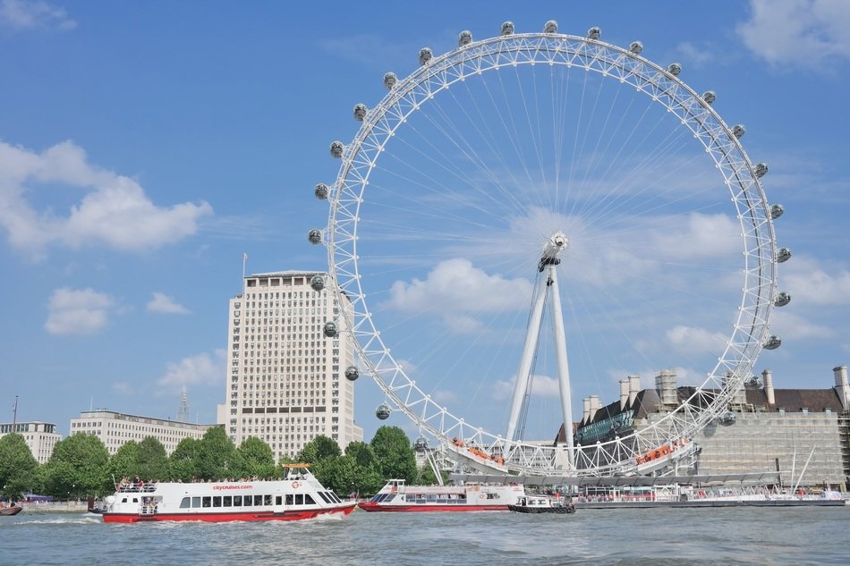 ships on river at london eye ferris wheel, uk, england