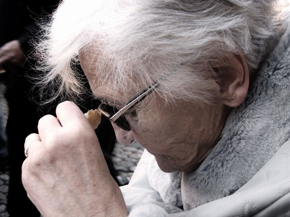 Sad old woman in profile close-up