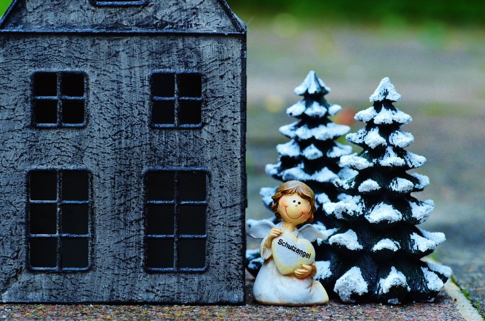 guardian angel near the house as a miniature model
