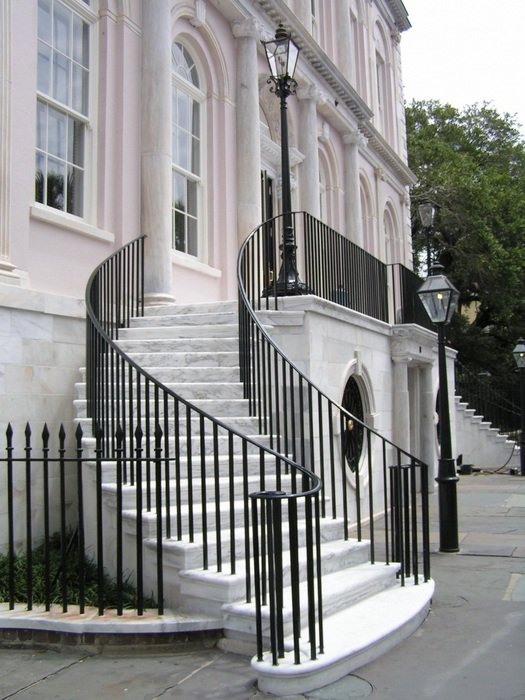 fenced staircase on street at house