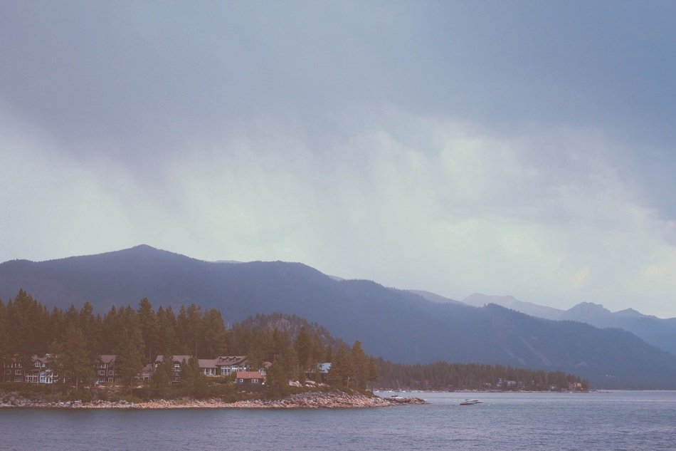 distant village among the plants on coast at foggy mountains