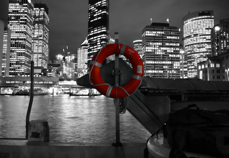red safety buoy ring on pier at nicht city, australia, sydney
