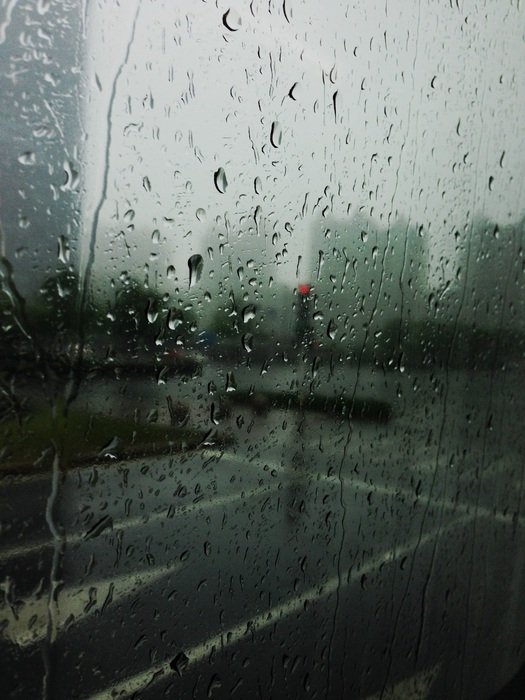 road through glass with rain drops