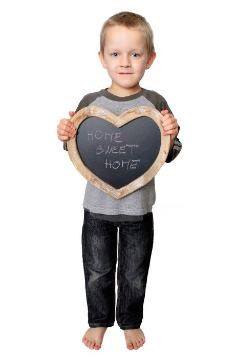 child boy holding heart form with lettering