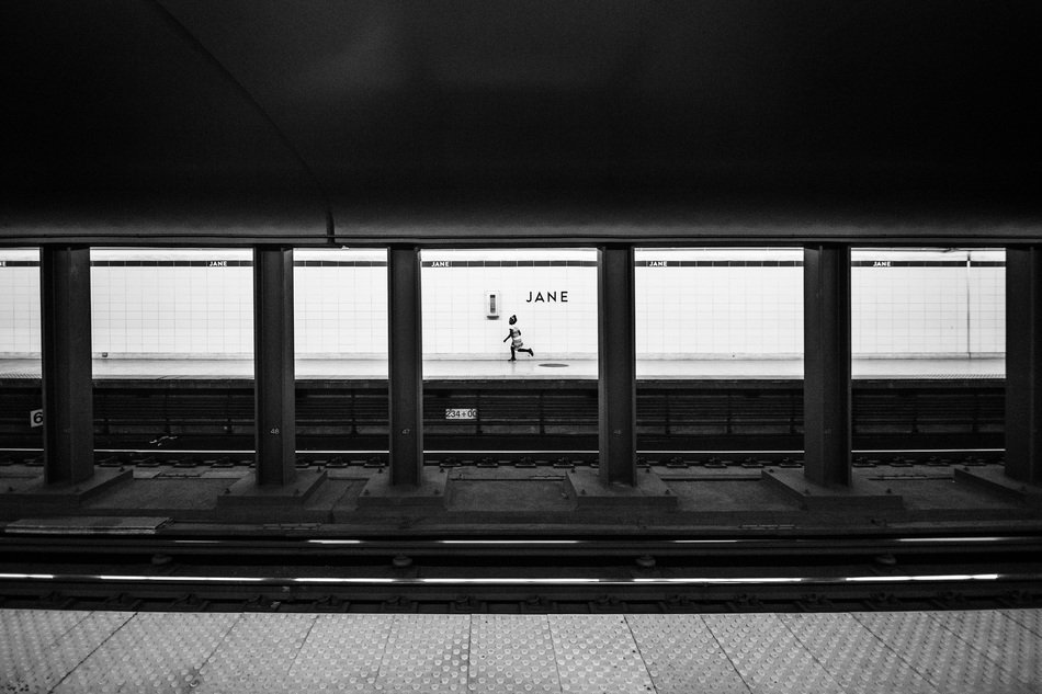 child running on platform of subway station