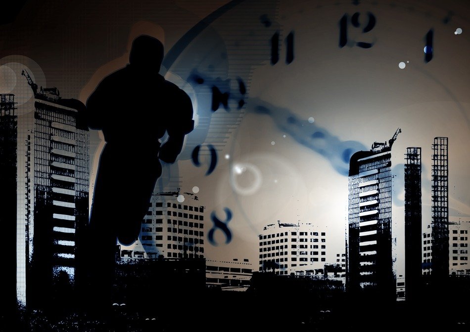 Silhouette of a man against a background of a city landscape and a clock face