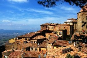 old red brick village buildings on hill, italy, tuscany