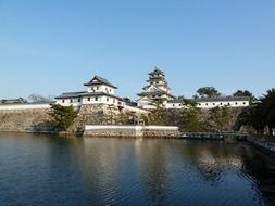 Imabari Castle behind wall above moat, Japan, Shikoku,