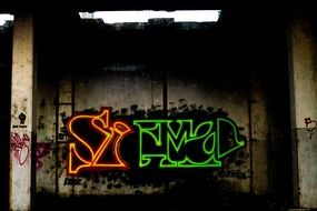 Neon graffiti on the factory building wall