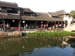 people at shops on waterfront, china, Zhouzhuang