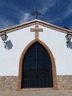 closed arched entrance door of old small church building