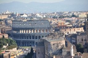 colosseum ruins in cityscape, italy, rome