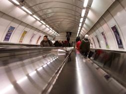 people on escalator in metro station, czech, prague