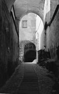 narrow arched passage at old facades