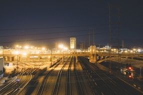 bridge across railway tracks at night city