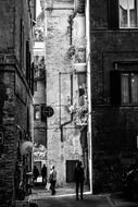 black and white photo of a street with buildings in Italy