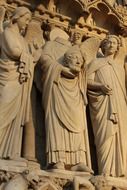 saints figures on gothic church facade, france, paris