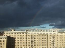 rainbow above old building at clouds, germany, berlin, karl marx allee