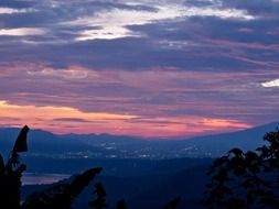 colorful clouds at sunset sky above countryside